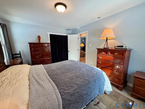 a bedroom with a bed and dresser