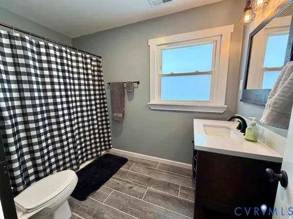 a bathroom with a sink toilet and a mirror