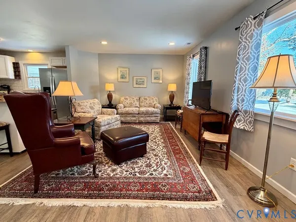 a living room with furniture a rug and a lamp