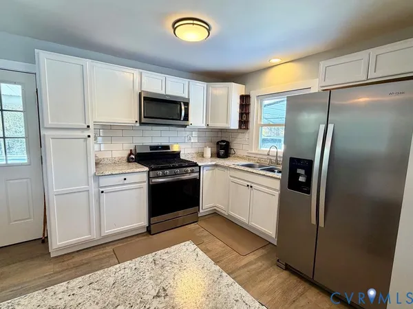 a kitchen with a sink stainless steel appliances and cabinets