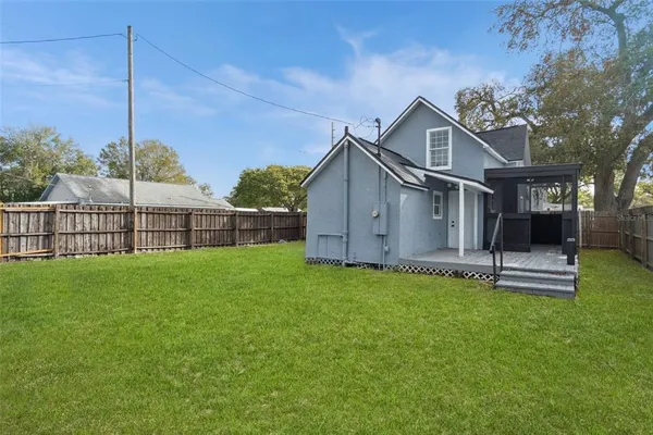 a view of a house with a yard and sitting area