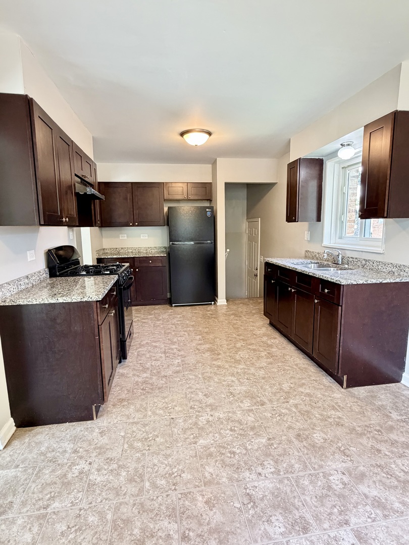1820 169th Street Hazel Crest, IL 60429 - Photo 11 of 23 a kitchen with stainless steel appliances a sink stove and refrigerator