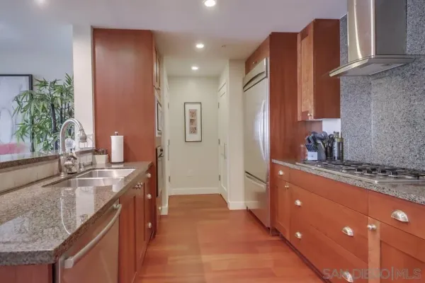 a kitchen with granite countertop a sink and cabinets