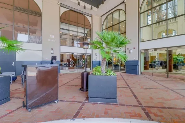 a view of a building with a potted plant and a bench