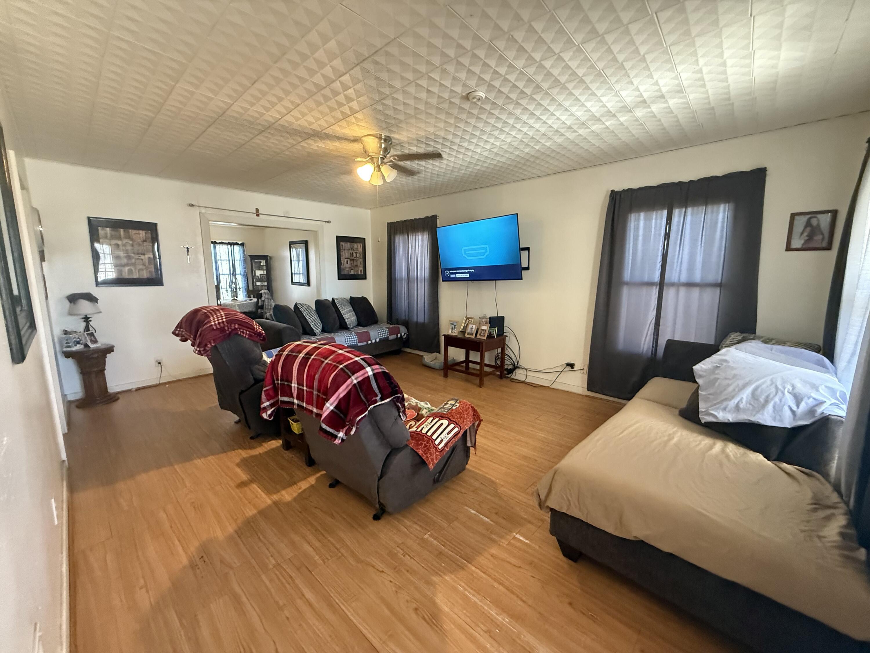 Package Package Property Lubbock, TX 79411 - Photo 9 of 71 a living room with furniture and a wooden floor