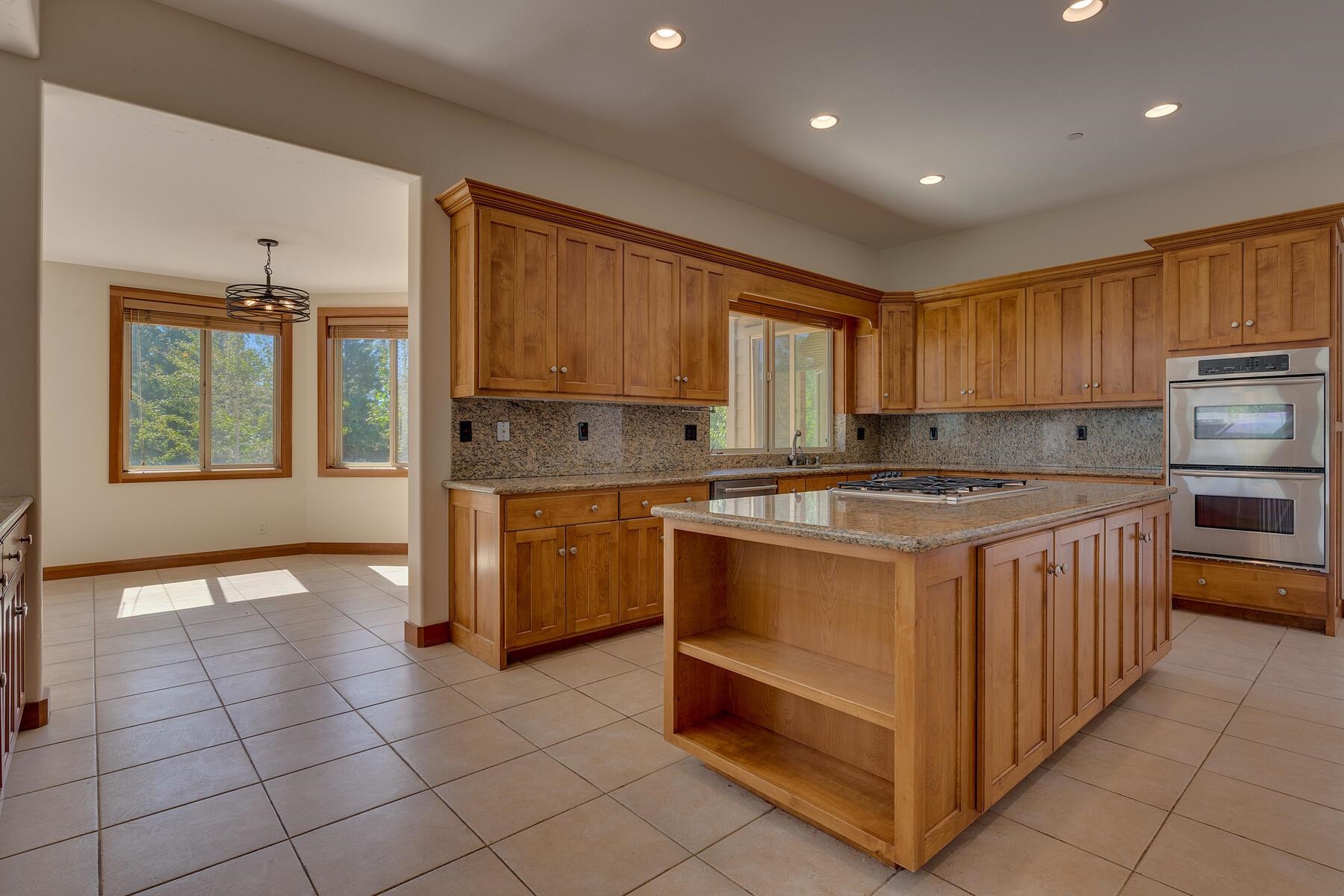 11939 Dove Terrace Truckee, CA 96161 - Photo 13 of 28 a kitchen with stainless steel appliances granite countertop a stove a sink and a refrigerator