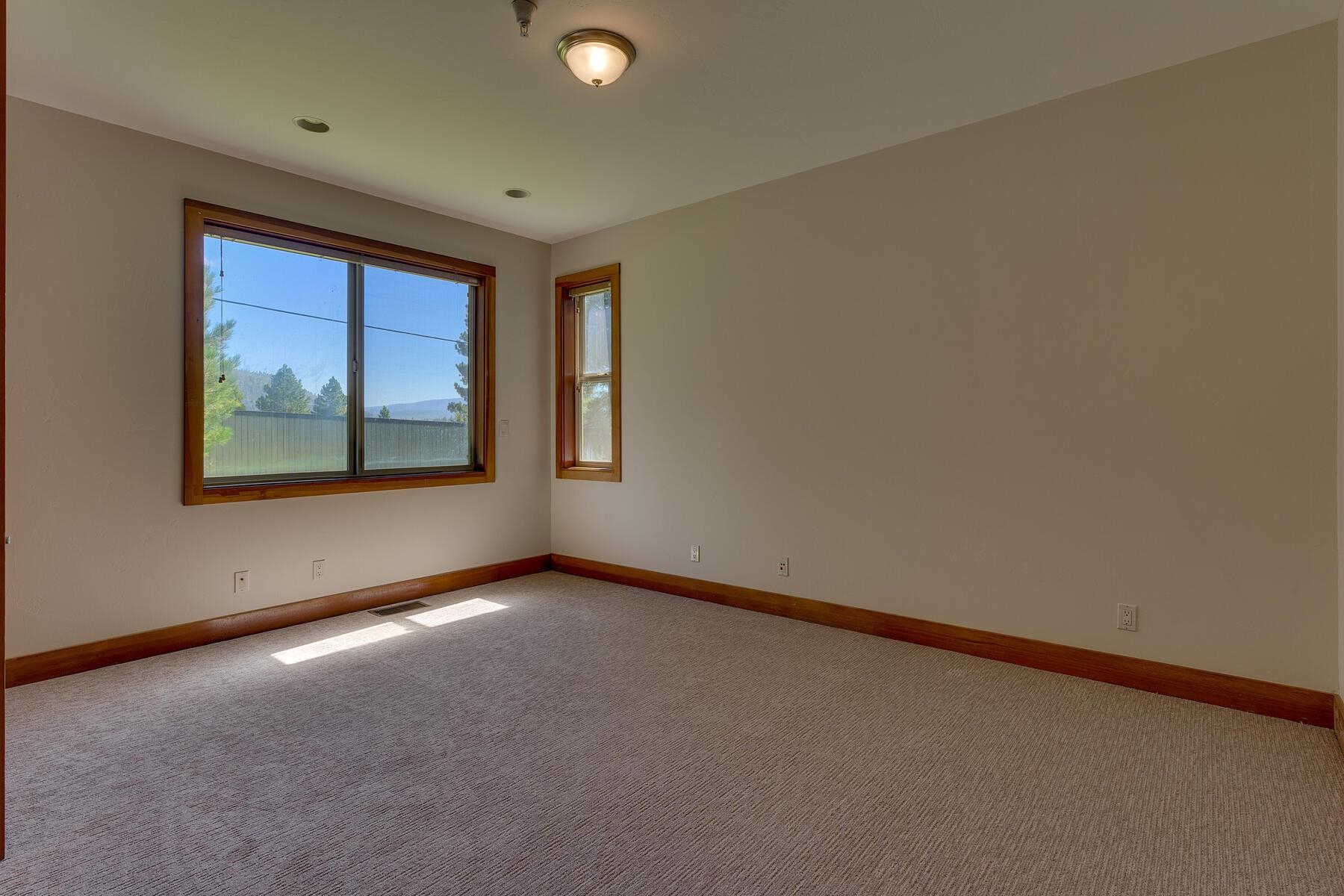 11939 Dove Terrace Truckee, CA 96161 - Photo 28 of 28 a view of a big room with windows and chandelier fan