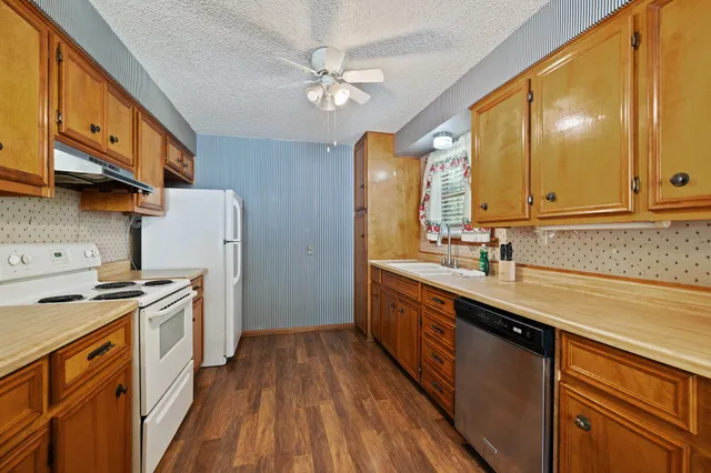 a kitchen with a sink a refrigerator and a stove