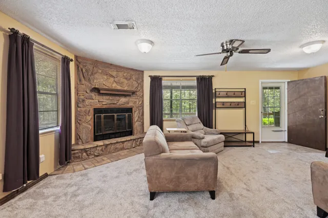 a living room with furniture and a fireplace