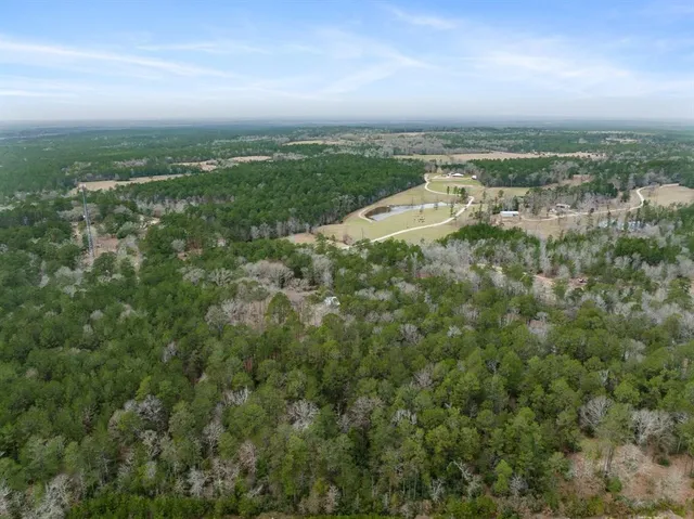 an aerial view of residential building with green space