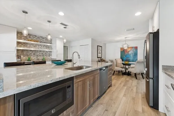 a kitchen with sink stove and cabinets