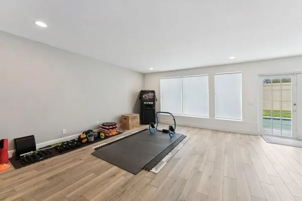 a room with wooden floor and gym equipment