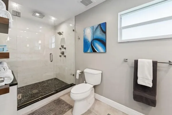 a bathroom with a toilet sink and shower