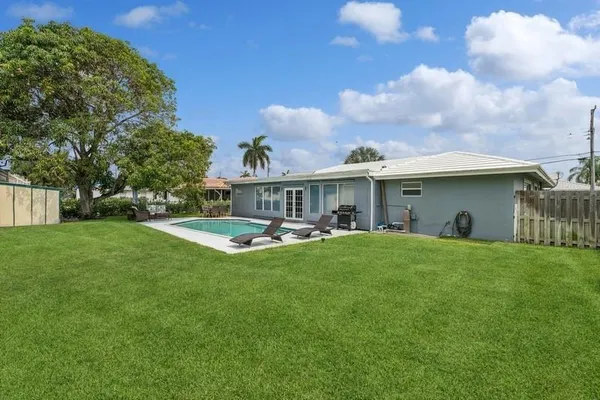 a front view of house with yard and outdoor seating