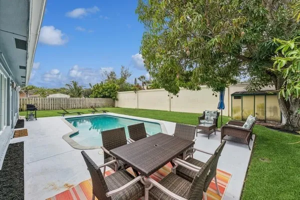 an outdoor sitting area with furniture and garden