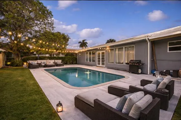 a view of a patio with swimming pool table and chairs