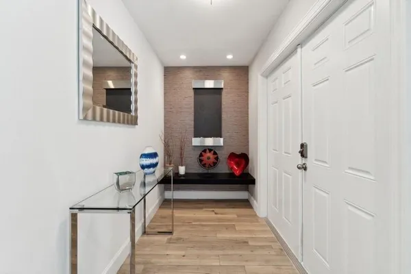 a living room with furniture and a baby crib