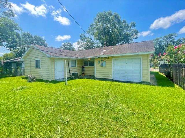 a backyard of a house with plants and a patio