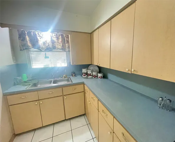 a kitchen with a sink and cabinets