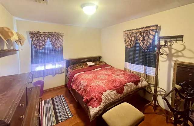 a bed sitting in a bedroom next to a lamp