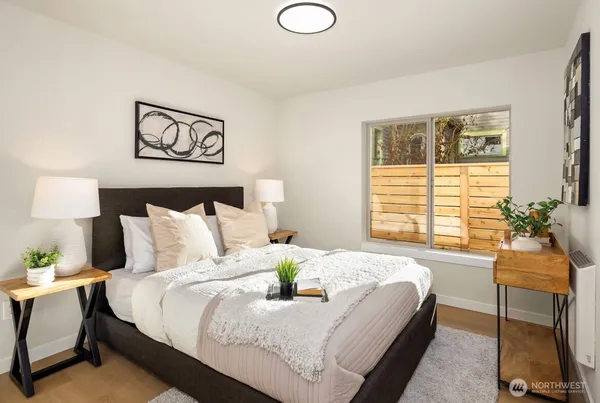 a bed sitting in a bedroom next to a window