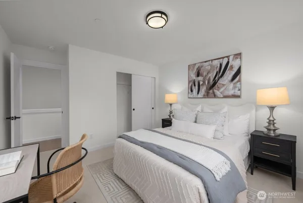 a bedroom with a bed and a lamp on table