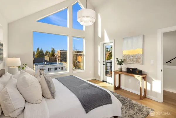 a bedroom with a bed and a chandelier