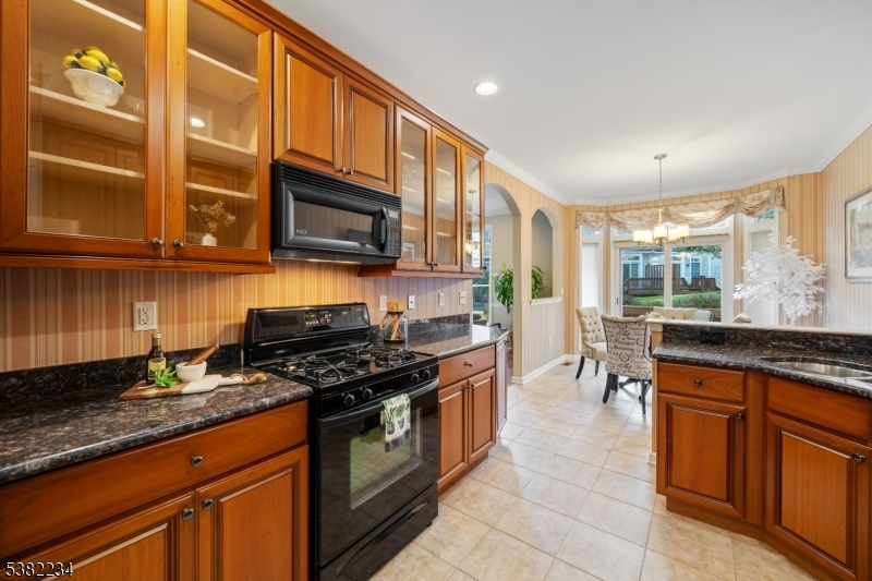 26 Chestnut Court Cedar Grove, NJ 07009 - Photo 12 of 43 a kitchen with stainless steel appliances granite countertop a stove a sink and a microwave