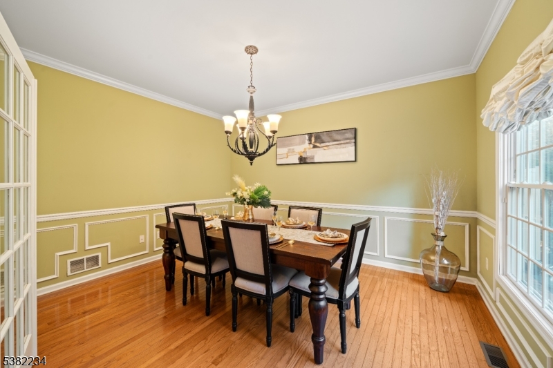 26 Chestnut Court Cedar Grove, NJ 07009 - Photo 15 of 43 a view of a dining room with furniture wooden floor and chandelier