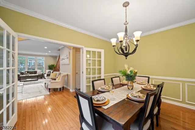 a view of a dining room with furniture wooden floor and chandelier