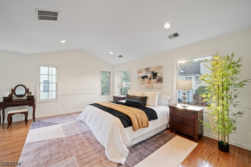 26 Chestnut Court Cedar Grove, NJ 07009 - Photo 20 of 43 a spacious bedroom with a bed and wooden floor