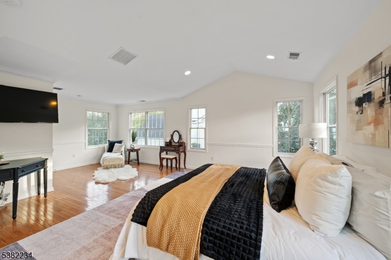 26 Chestnut Court Cedar Grove, NJ 07009 - Photo 21 of 43 a spacious bedroom with a bed and a flat screen tv