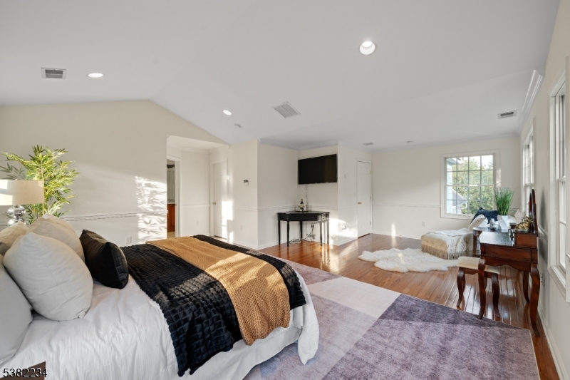 26 Chestnut Court Cedar Grove, NJ 07009 - Photo 22 of 43 a spacious bedroom with a bed and a table