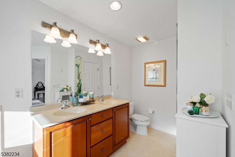 26 Chestnut Court Cedar Grove, NJ 07009 - Photo 25 of 43 a bathroom with a double vanity sink and a mirror