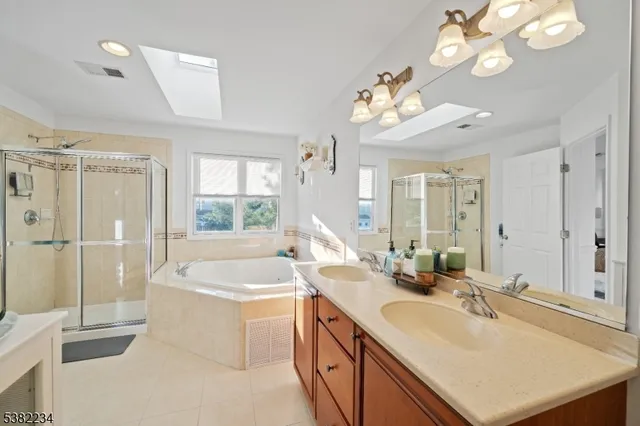 a bathroom with a sink a large mirror and a bathtub