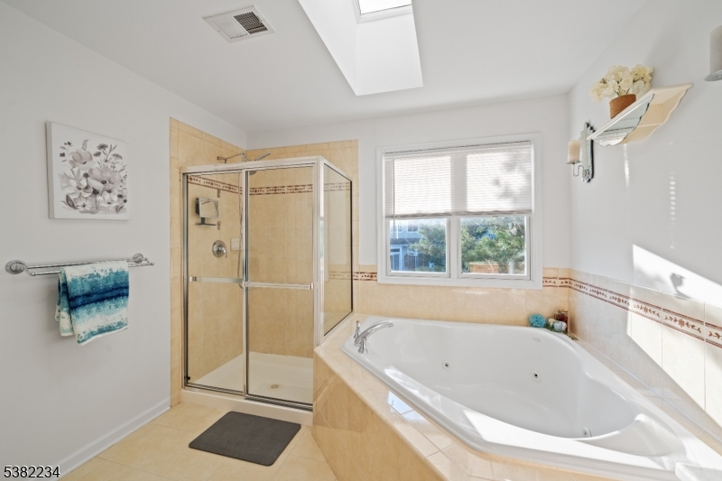 26 Chestnut Court Cedar Grove, NJ 07009 - Photo 27 of 43 a bathroom with a bathtub and a shower