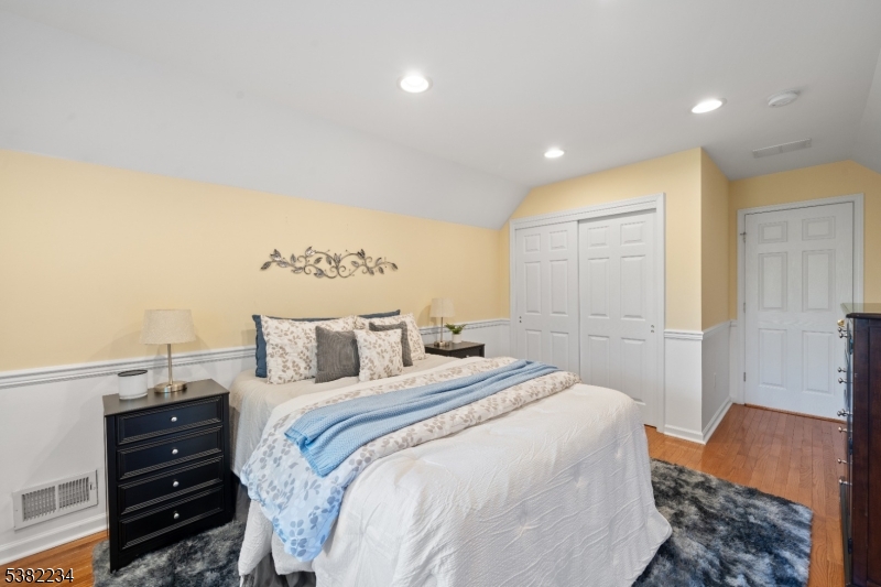 26 Chestnut Court Cedar Grove, NJ 07009 - Photo 30 of 43 a bedroom with a bed and wooden floor