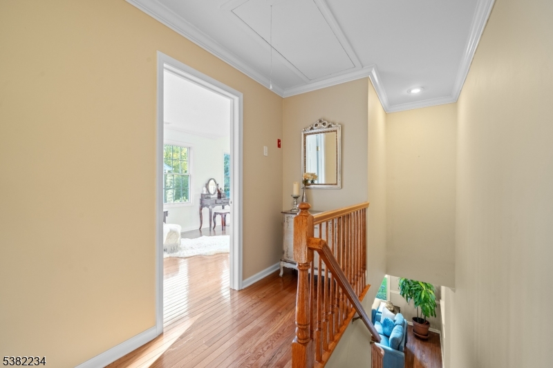 26 Chestnut Court Cedar Grove, NJ 07009 - Photo 33 of 43 a view of a hallway with wooden floor and a dining room