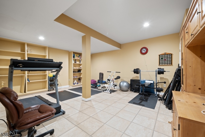 26 Chestnut Court Cedar Grove, NJ 07009 - Photo 37 of 43 a room with furniture a flat screen tv and gym equipment