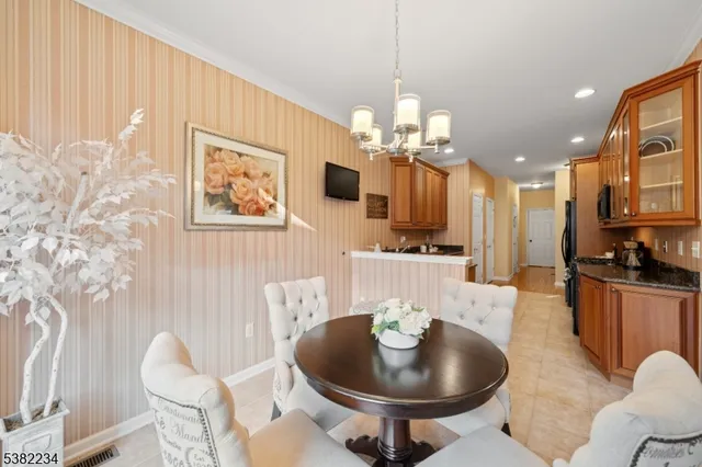 a living room with furniture kitchen and a chandelier