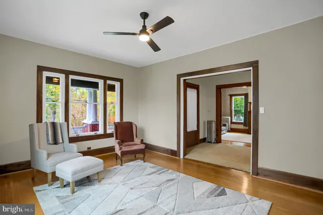 a living room with furniture and a floor to ceiling window