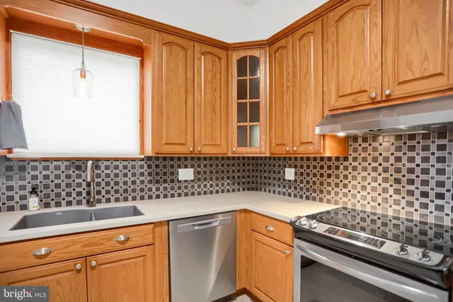 a kitchen with a sink a stove and cabinets