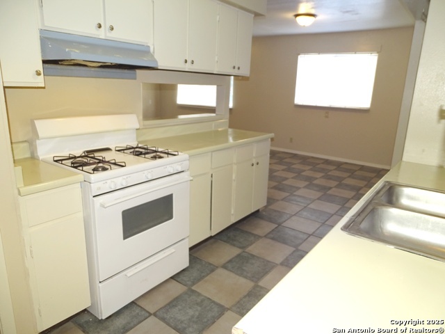 7338 Deep Spring Drive San Antonio, TX 78238 - Photo 8 of 33 a stove top oven sitting inside of a kitchen