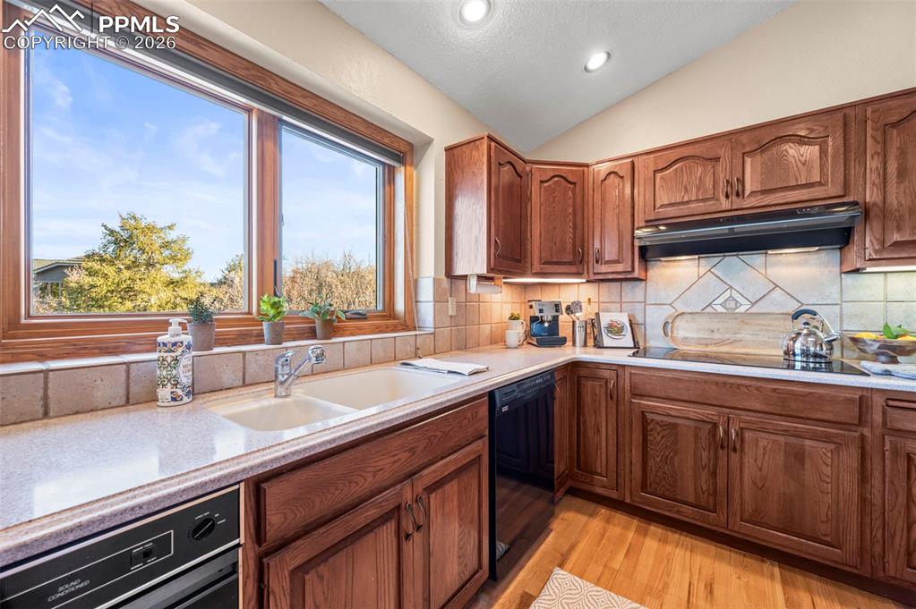735 Pollux Drive Colorado Springs, CO 80906 - Photo 11 of 50 a kitchen with a sink stove and cabinets