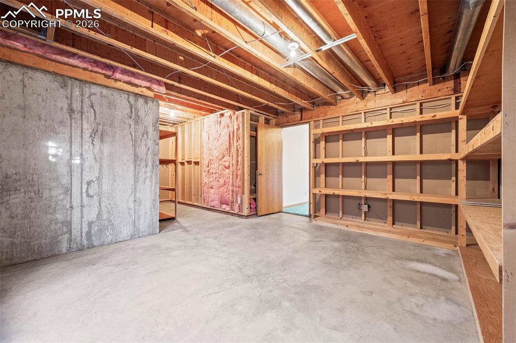 735 Pollux Drive Colorado Springs, CO 80906 - Photo 39 of 50 a view of an empty room with wooden floor and a window
