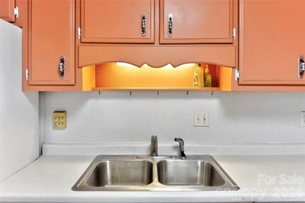 a kitchen with a sink and a window