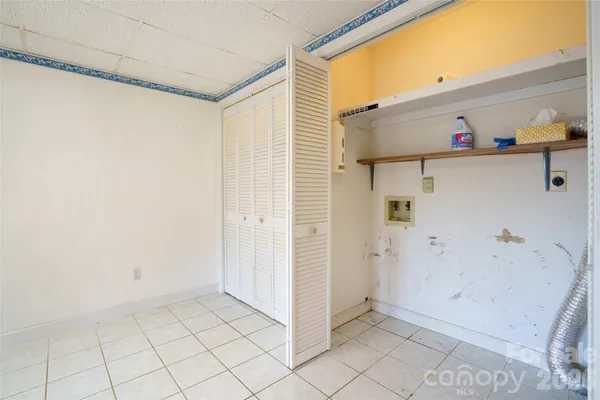 a view of a storage & utility room with a window