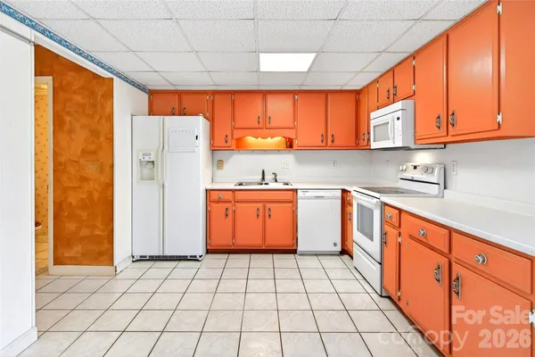 a kitchen with stainless steel appliances a refrigerator sink and cabinets