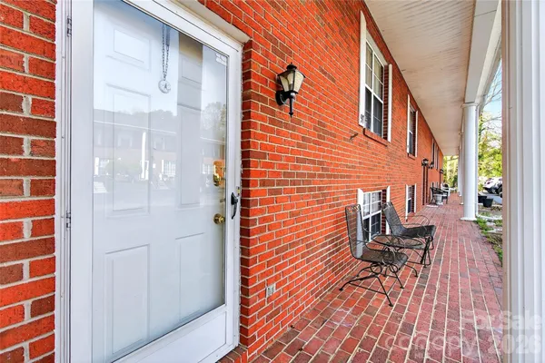 a balcony view with a bench and a rug