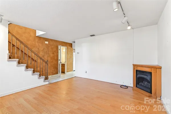 a view of an empty room with stairs